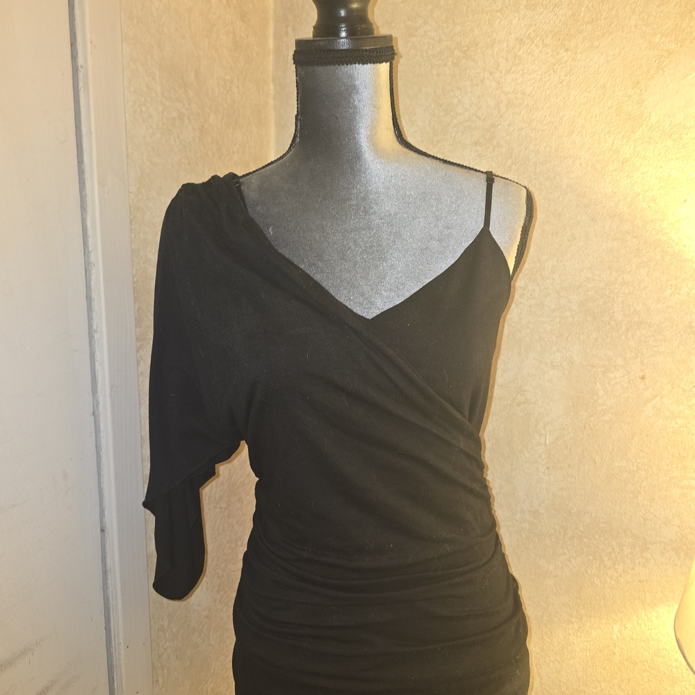 Elegant Black One-Shoulder Top. The Bottom Is A Leather Mini Skirt